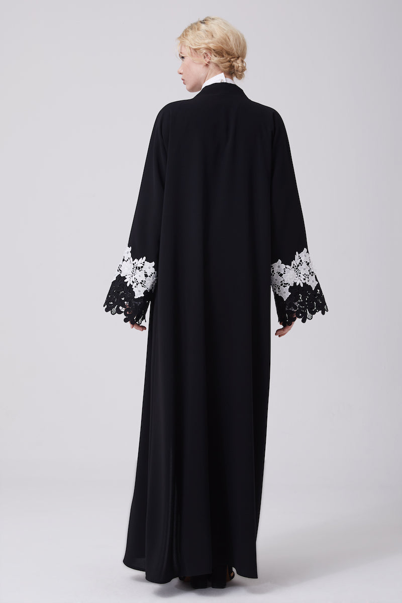 FERADJE modest black abaya with black and white lace on sleeves made from crepe back view