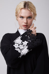 FERADJE modest black abaya with black and white lace on sleeves made from crepe close up view