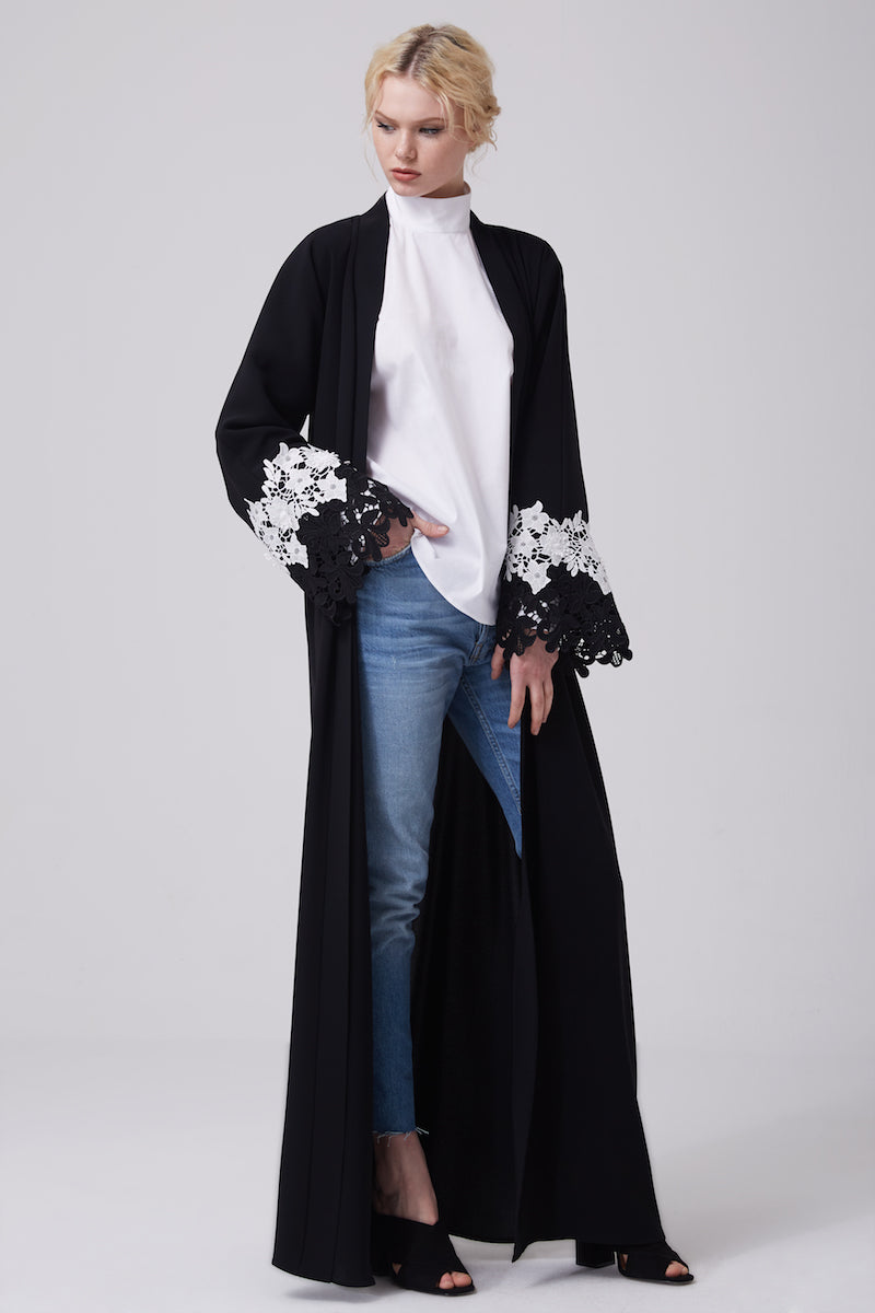FERADJE modest black abaya with black and white lace on sleeves made from crepe front view