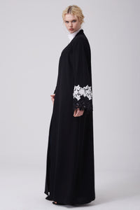 FERADJE modest black abaya with black and white lace on sleeves made from crepe side view