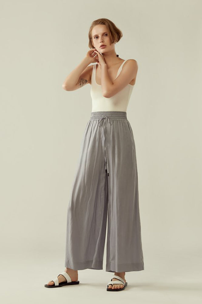 r y e Cupro Drawstring Flared Pants in Light Slate Modest Loose Fitting Ankle-Length Grey Trousers With Pockets, Elastic Waistband