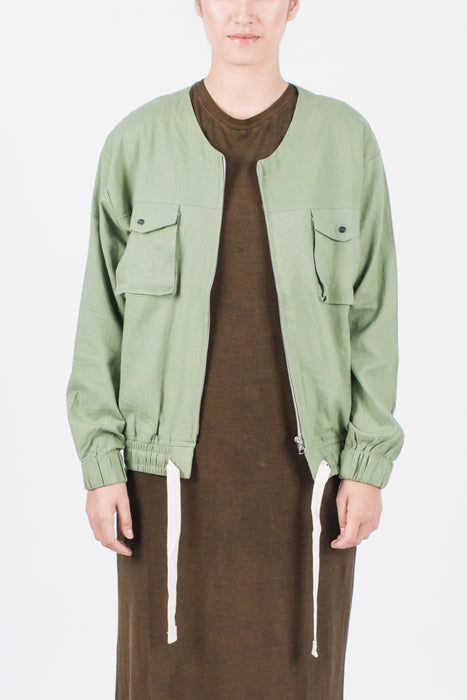 Muzca Imogen Linen Jacket In Green Modest Loose Collarless Jacket with Zipper, Chest Pockets, and Drawstring in Linen